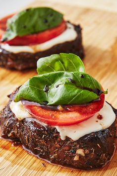 two small sandwiches with tomatoes, cheese and spinach