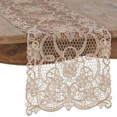 two pieces of lace sitting on top of a wooden table