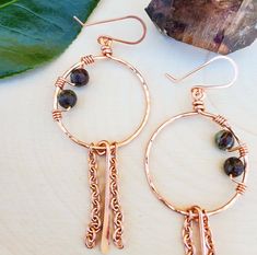 Handmade and hand hammered/textured copper hoop earrings with wire wrapped Jasper **Details** Earrings are approximately 3 inches 16g Copper wire handmade hoops 20g Copper handmade ear wires 6mm Faceted Dragons Blood Jasper gemstones **Important Info** *The colors may appear to be slightly different than the picture due to the natural variations in gemstones, as well as screen quality or settings. *Please handle with care as handmade items may be more fragile than factory made products. Hand Forged Copper Dangle Hoop Earrings, Hand Forged Copper Hoop Earrings With Dangle, Bohemian Dangle Hoop Earrings With Copper Wire, Artisan Copper Dangle Hoop Earrings, Small Copper Wire Wrapped Hoop Earrings, Bohemian Hoop Earrings With Copper Wire, Handmade Copper Wire Hoop Earrings, Bohemian Copper Wire Wrapped Earrings, Dragons Blood Jasper