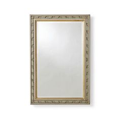 a large mirror hanging on the wall next to a white wall with a gold frame