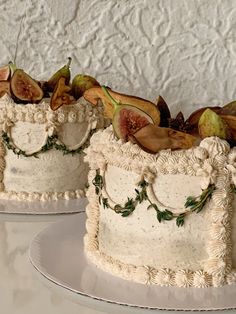 two cakes decorated with figurines and leaves