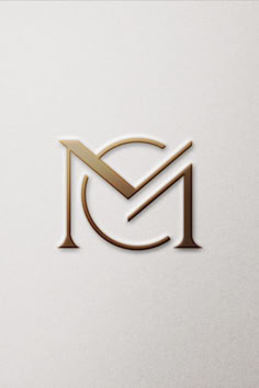 the letter m is made up of gold and white letters, which are placed on top of each other