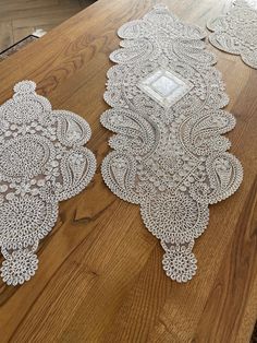 two white lace doily on a wooden table