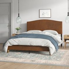 a large bed sitting on top of a wooden floor