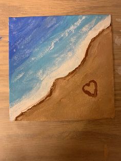 an acrylic painting of a beach with a heart on it