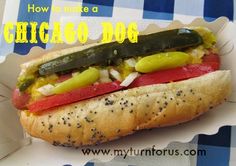 there is a hot dog with pickles and onions on it