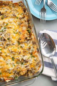 a casserole dish with meat, cheese and green onions