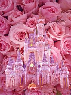 a pink castle is surrounded by flowers