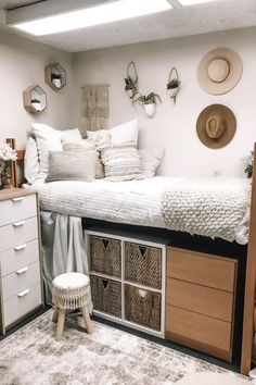 a bedroom with a bed, dressers and hats on the wall