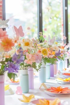 there are many flowers in vases on the table