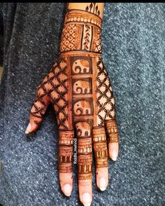 a woman's hand with henna tattoos on it