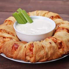 a white plate topped with an appetizer filled with meat and cheese covered pretzels