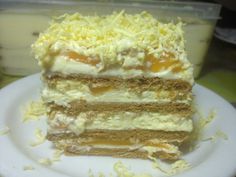 a piece of cake sitting on top of a white plate next to a plastic container