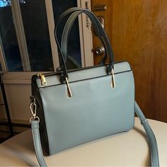 Great Condition, Never Used Tote Bag With Patterned Lining And Several Pockets! Faux Leather With Gold Zippers And Detailing And A Detachable Shoulder Strap. The Bag Measures 6” W X 12” L X 10” H. Kind Of A Soft, Dusty Turquoise Or Teal. Send Me An Offer! Blue Rectangular Bag For Fall, Rectangular Blue Bag For Fall, Blue Shoulder Bag For Daily Use In Fall, Blue Bag With Adjustable Strap For Fall, Blue Bags With Adjustable Strap For Fall, Versatile Large Capacity Blue Satchel, Fall Travel Blue Shoulder Bag, Trendy Blue Bags For Fall, Casual Blue Shoulder Bag For Office