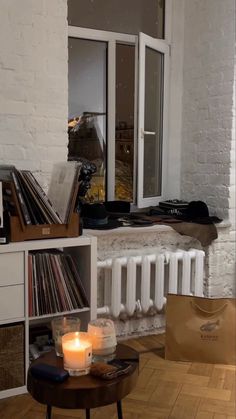 a living room filled with furniture and a fire place next to a white brick wall