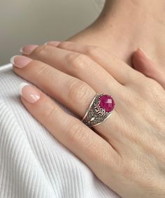 This everyday use, lace embroidery 925 sterling silver filigree art Greek key cocktail ring has natural opaque dyed ruby corundum gemstone.  This stunning sterling silver meander ring is a modern take on the classic crown. Greek keys, known as meanders, were geometric motifs used by ancient Greeks to represent infinity, unity, and life's eternal flow. The ring face is 0.47 of an inch (12 mm) and comes with a ruby corundum gemstone that's 10 mm long and has been faceted to round-cut to enhance the stone's beauty. This versatile piece looks great with both day and evening attire and features a smooth oxidized finish, ensuring lasting beauty in any lighting. We love its versatility since it lends itself to different ensembles on any occasion. Whether you're looking for a subtle accent or some Ruby Filigree Ring As Gift, Ornate Ruby Ring With Filigree Detail, Silver Filigree Ruby Ring With Intricate Design, Ornate Ruby Filigree Ring With Gemstone, Ornate Ruby Ring With Gemstone, Ruby Ring With Filigree Detail As Gift, Ruby Ring With Filigree, Ruby Ring With Filigree As Gift, Ruby Ring With Filigree For Gift