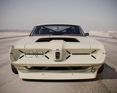 the front end of a white muscle car