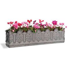 a metal planter filled with pink and purple flowers