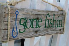 a wooden sign that says gone fishing on it