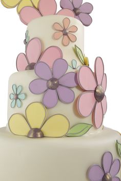 a three tiered cake decorated with flowers