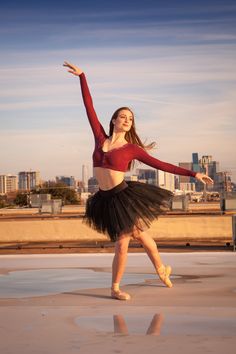 a woman in a red top and black tutu dancing