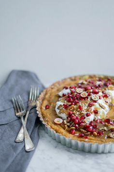 there is a pie on the table with silverware next to it