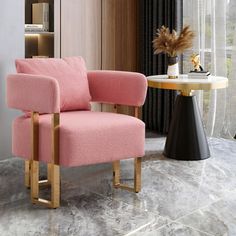 a pink chair sitting next to a table with a vase and plant on top of it