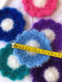 there is a measuring tape on top of some colorful pieces of yarn that have been sewn together