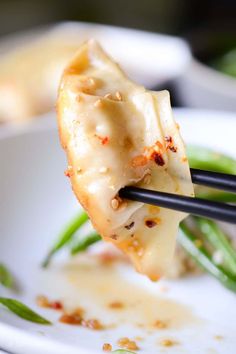 a close up of a plate of food with chopsticks sticking out of it