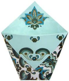 an origami box with blue and green designs