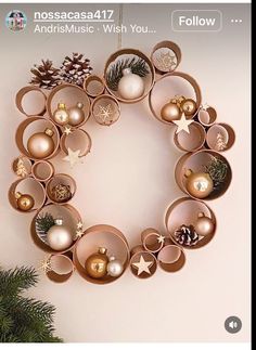 a christmas ornament hanging from the side of a wall next to a pine tree