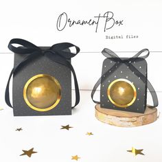 two black boxes with gold decorations on them