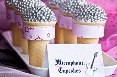 three ice cream cones with silver sprinkles and a name tag on a plate