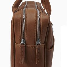 a brown bag with two zippers on it