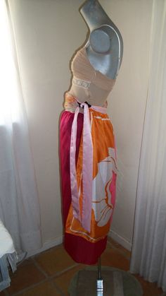 1920s 1930s style . . .An original design by me, very unique and one of a kind.  Sarong, sari, palero,  dress or skirt made out of vintage silk scarfs from the 1950s through the 1970s.  Tie belt, shown worn as dress wrapped around neck and as hair tie/headband.  Beautiful, lovely, there will never be another one like it.  You can wear this many ways, skirt, halter dress, wrap dress, strapless dress, with the material showing in different ways. One size fits most.   Length:  37" on one side & the middle; 34" on the other side Width:  65 1/2" Silk Scarfs, 1930s Style, Tie Headband, Vintage Silk Scarf, Dress Wrap, 1930s Fashion, Dress Silk, Silk Sari, Skirt Dress