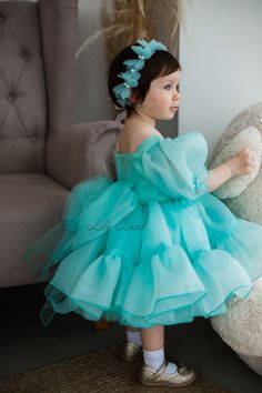 This Mint Tutu & Tulle Puffy Flower Girl Dress is perfect for a First Baby Birthday Party, Princess Girl Gown, Pageant or any Special Occasion.  The dress features a beautiful butterfly design and is made with high-quality tulle fabric. The dress is both elegant and playful, making it a great choice for any little girl who wants to feel like a princess. Features: - knee length - short puffy sleeve - multicolored butterfly - big bow from the back ACCESSORIES By request baby dress can be with: - B Green Ruffled Tutu Dress For Wedding, Blue Ruffled Princess Dress For First Birthday, Blue Princess Dress For First Birthday In Spring, Spring Birthday Gown With Ruffles, Organza Tutu Dress With Ruffles For First Birthday, Blue Tulle Dress For First Birthday, Spring Birthday Organza Dress, Birthday Tulle Gown With Ruffles, Birthday Gown With Tulle Ruffles