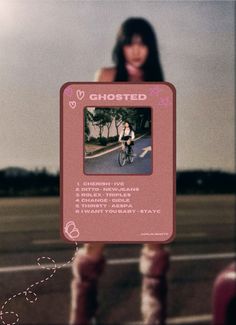 a woman riding a bike down a street next to a pink sign that says ghosted