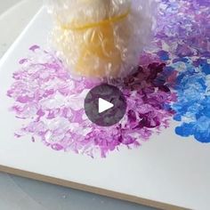 a white cutting board topped with lots of purple and blue flowers