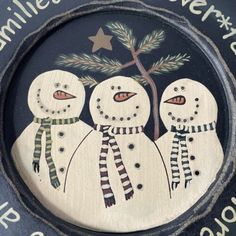 two snowmen are standing next to each other in front of a plaque that says, families forever