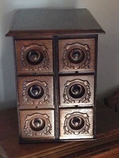 an old wooden box with four speakers on it's sides sitting on top of a table