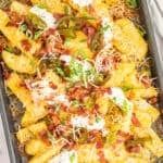 a pan filled with pasta and vegetables on top of a table