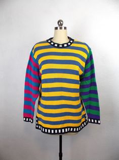 "Vintage 1980's 1990's oversized style striped sweater in colorful color block pattern. Very good vintage condition.  Label: LizWear Petites 100% cotton Size: Petite S  Length 24\" Shoulders 18\" Sleeves 23\" Bust 36\" Waist 38\" *Please note that vintage clothing and contemporary sizes can vary greatly. We take measurements of listed garments by laying the garment flat and then doubling the measurement. When considering whether a garment would fit, we suggest taking a similar garment from your own wardrobe and measure it lying flat as we do. Then compare the measurements." Winter Multicolor Striped Sweater, Multicolor Long Sleeve Sweater With Contrast Stripes, Oversized Striped Color Block Sweater, Retro Striped Color Block Sweater, Vintage Striped Sweater For Spring, Oversized Multicolor Retro Sweater, Retro Striped Crew Neck Sweater, Oversized Multicolor Vintage Sweater, Vintage Multicolor Color Block Sweater