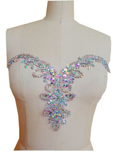 the back of a mannequin with lots of jewels on it's neck