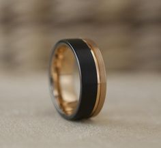 a black and gold wedding band with an inlay