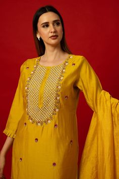 Elevate your wardrobe with the Yellow Silk Kurti Set. This set stands out with its intricate embroidery work. It transcends seasonal trends, offering versatility for various occasions. Whether it's a family gathering, festive celebration, or formal event, the Yellow Silk Kurti Set ensures you stand out with elegance. Its timeless appeal guarantees it as a cherished piece in your collection for years to come. Embroidered Sets For Wedding And Diwali, Embroidered Fitted Palazzo Set In Dola Silk, Traditional Floral Embroidered Palazzo Set For Wedding, Traditional Floral Embroidery Palazzo Set For Wedding, Chinon Traditional Wear With Long Sleeves For Diwali, Fitted Embroidered Raw Silk Palazzo Set, Long Sleeve Palazzo Set With Intricate Embroidery For Festivals, Festive Anarkali Set With Intricate Embroidery For Eid, Festive Cotton Silk Sharara For Navratri