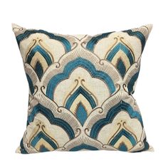 a blue and white pillow with an intricate design on the front, sitting against a white background