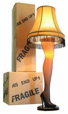 a lamp that is sitting on top of a table next to a box with the word fragile written on it