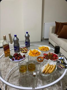 a glass table topped with lots of food