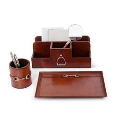 a brown leather desk set with pen, magnifying glass and business card holder