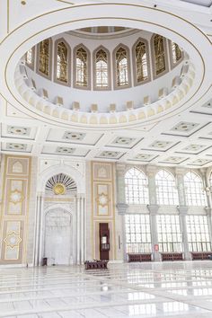 the inside of a large building with many windows and arches on it's ceiling